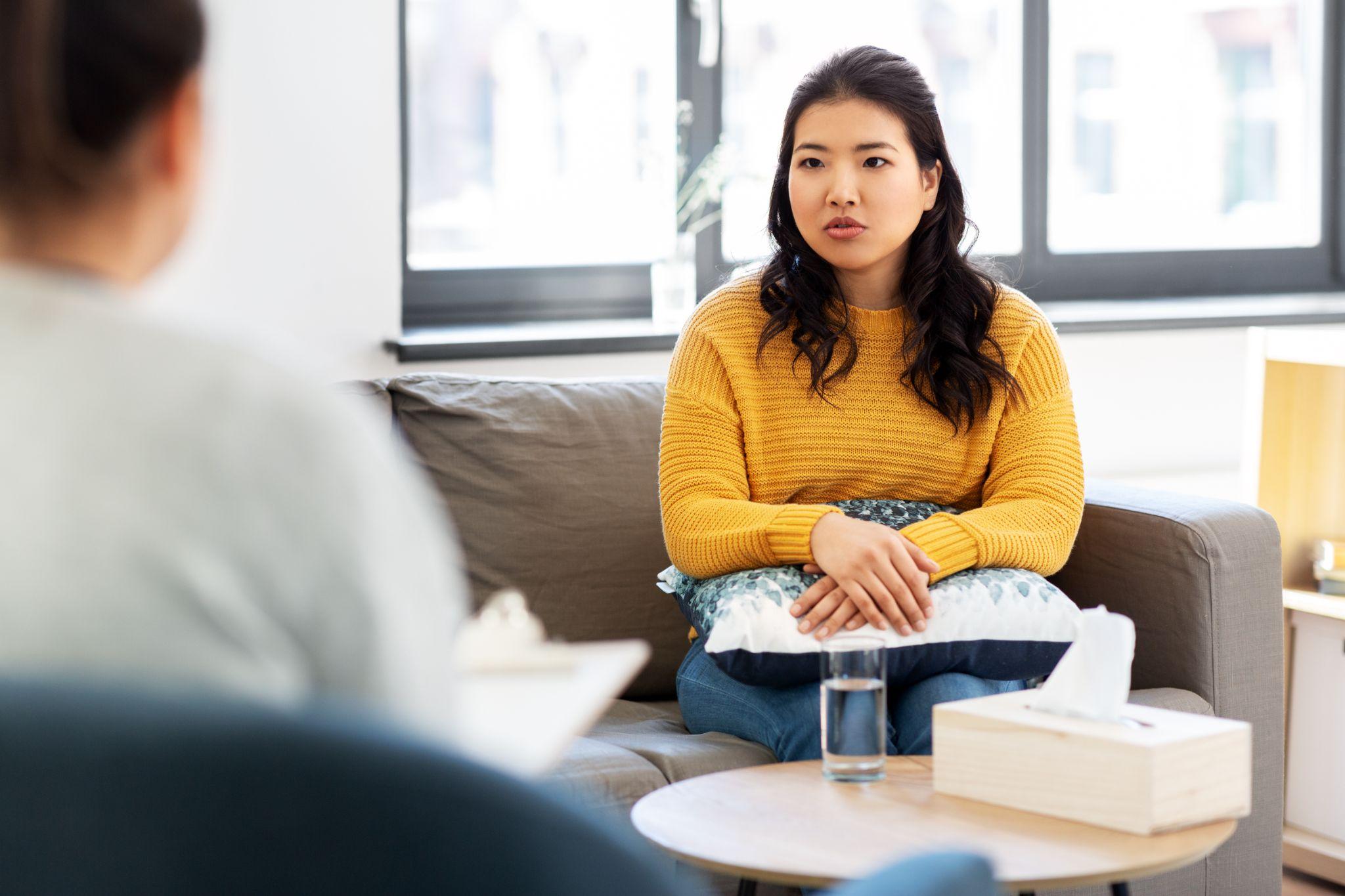 young asian woman patient and psychologist at psychotherapy session