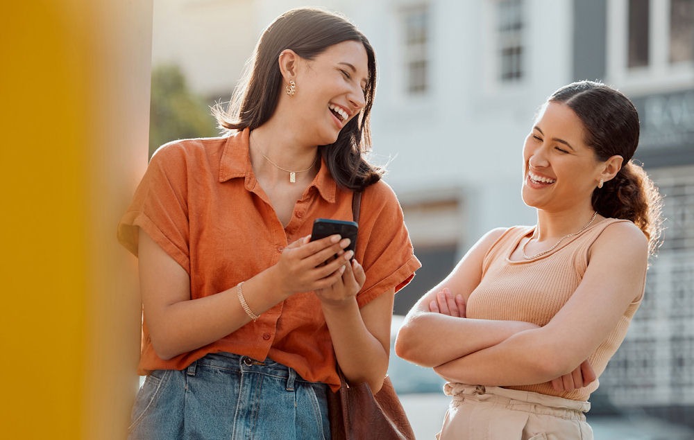 two female friends outside laughing