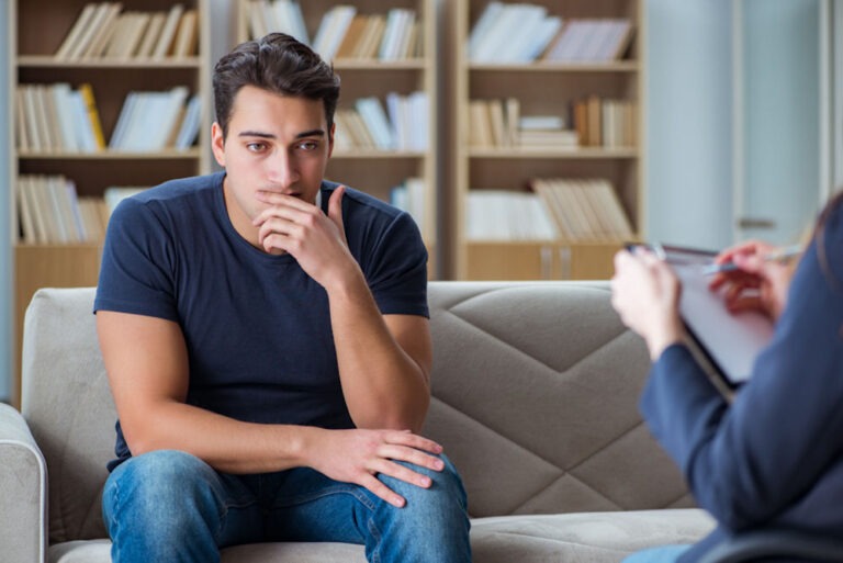 Young man discussing addiction with therapist