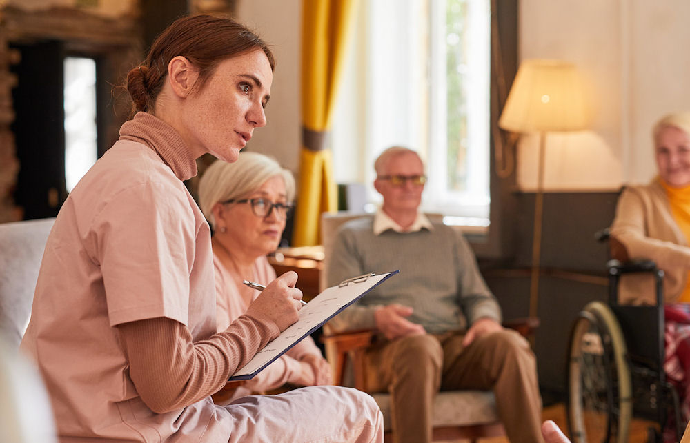 Nurse taking intake information of older adults in sentior addiction treatment group