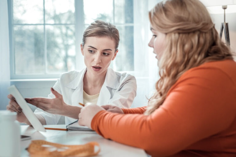 Nurse reassuring young man entering alcohol treatment