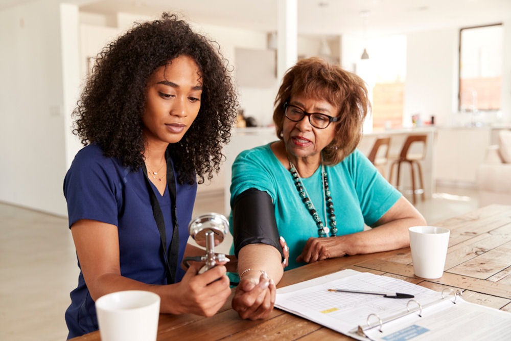 an elderly getting her blood pressure checked at an addiction treatment center